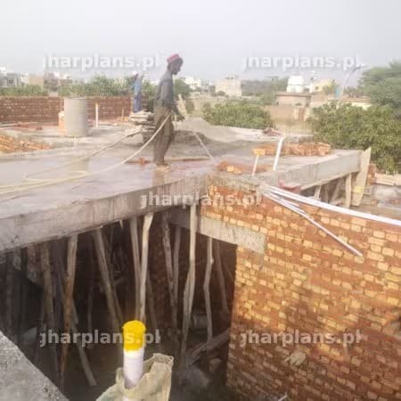 Curing of brick walls at construction site in Pakistan Curing of brick walls at construction site in Pakistan
